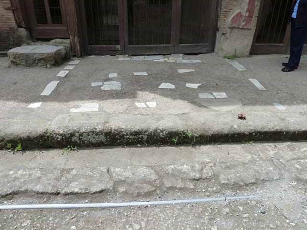 V.17, Herculaneum. May 2010. Outside entrance. Note the gutter/drainage channel.